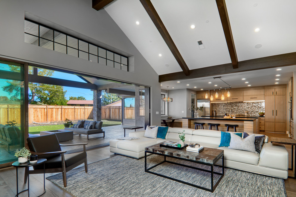 Large contemporary open concept family room in San Francisco with grey walls, dark hardwood floors, a ribbon fireplace, a stone fireplace surround, a built-in media wall and brown floor.