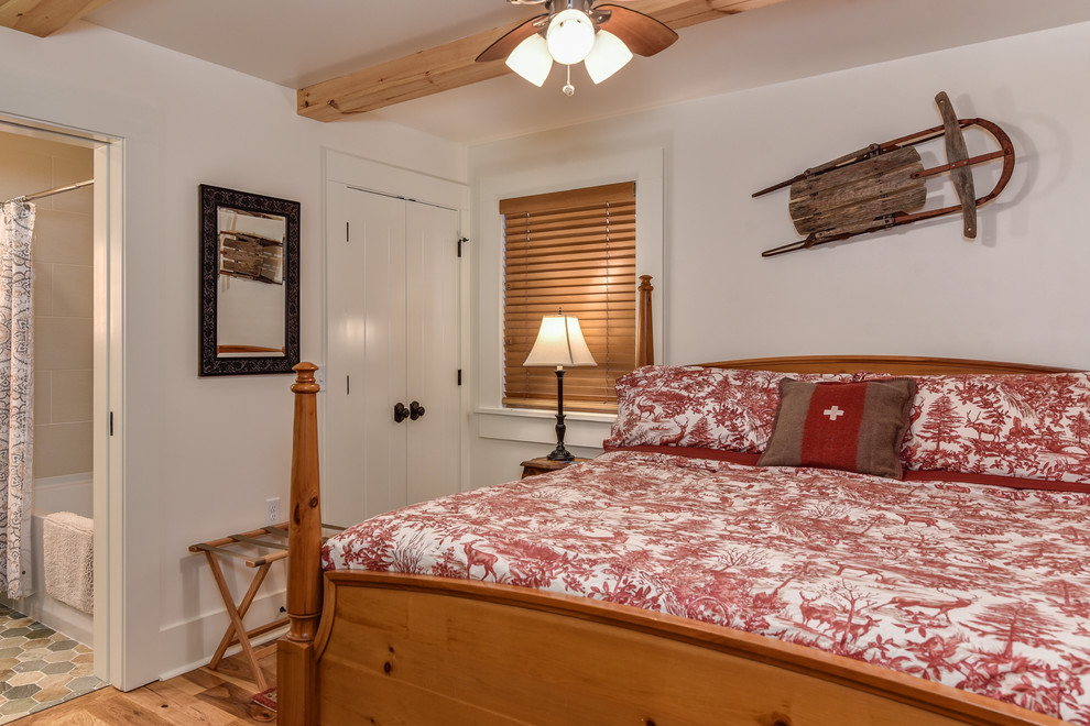 Design ideas for a small country bedroom in Other with white walls and light hardwood floors.
