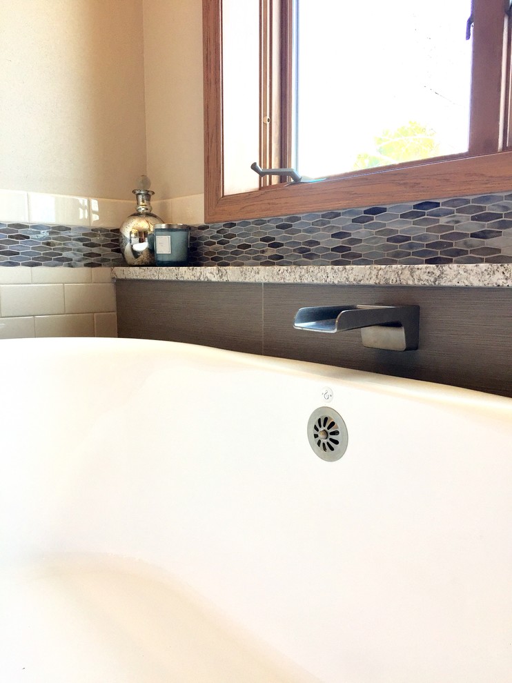 Example of a transitional master multicolored tile and mosaic tile porcelain tile and brown floor freestanding bathtub design with shaker cabinets, white cabinets, a vessel sink, quartz countertops, a hinged shower door and multicolored countertops