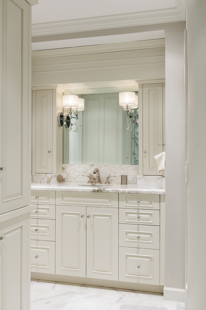 Design ideas for a mid-sized traditional master bathroom in Miami with an undermount sink, raised-panel cabinets, white cabinets, marble benchtops, an alcove shower, a one-piece toilet, gray tile, stone tile, grey walls and marble floors.
