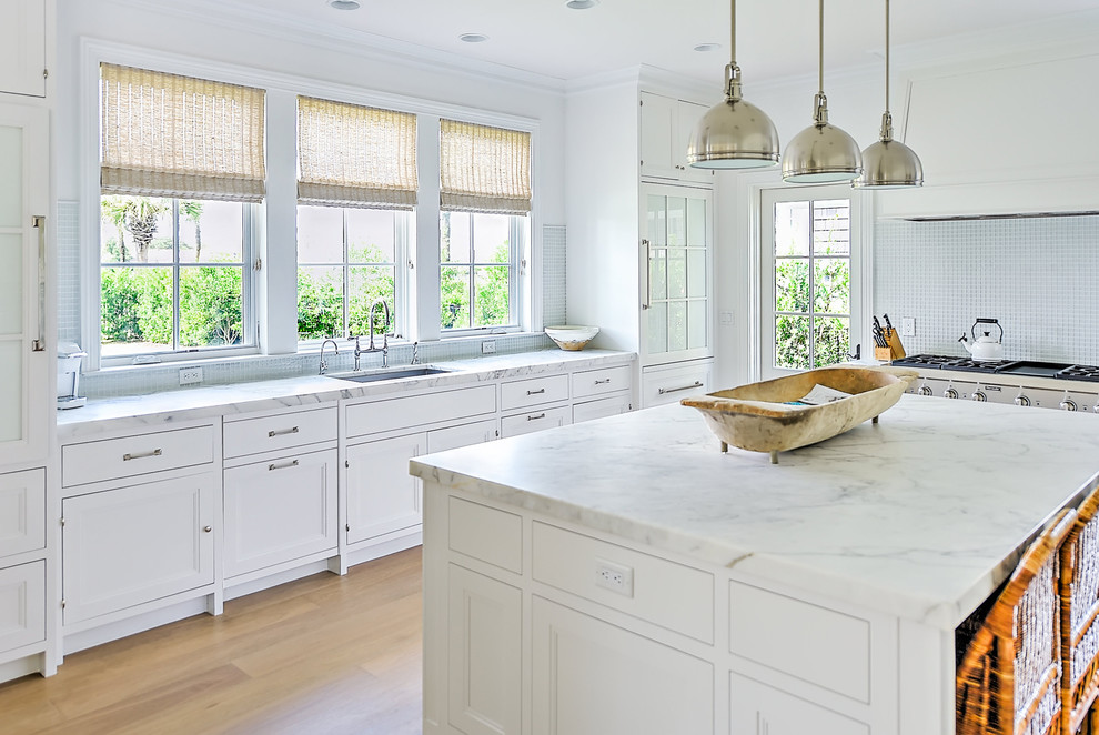 Transitional kitchen photo in Jacksonville with white cabinets, marble countertops, an island and white countertops