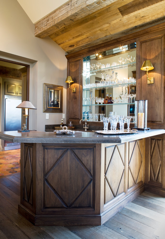 Photo of a large traditional l-shaped wet bar in Orange County with raised-panel cabinets, medium wood cabinets, quartzite benchtops and grey benchtop.