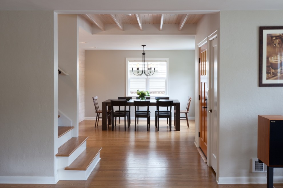 Photo of a mid-sized transitional entry hall in Seattle with beige walls, light hardwood floors, a single front door, a light wood front door and brown floor.