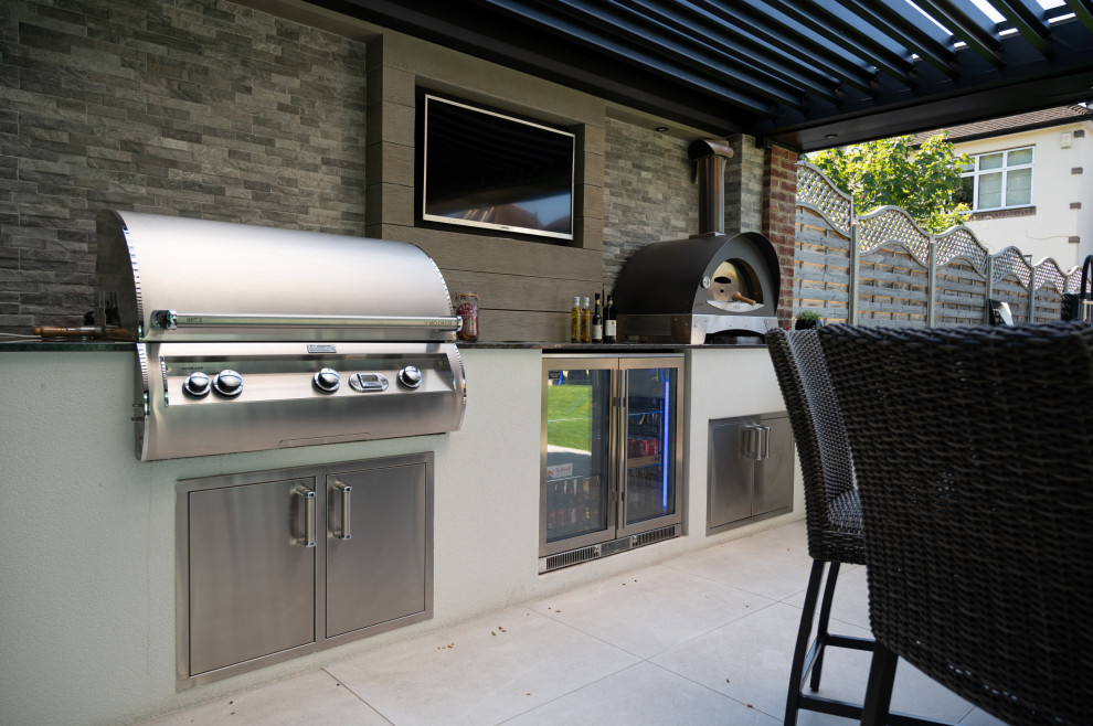 Example of a large tile patio kitchen design in DC Metro with a pergola