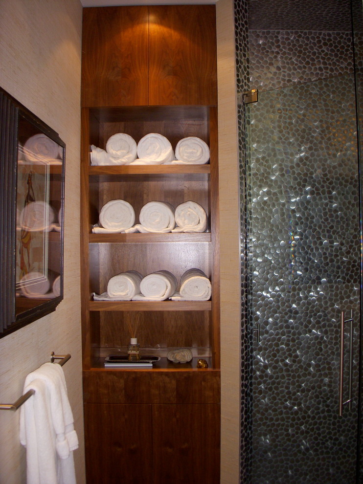This is an example of a small modern powder room in Tampa with porcelain tile and beige walls.