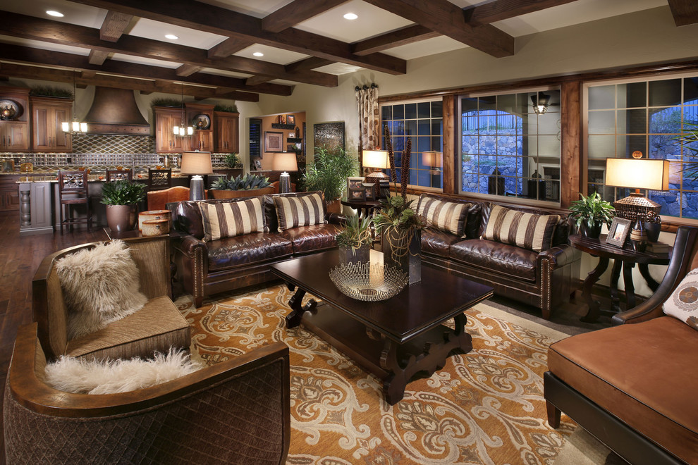 Inspiration for a mediterranean open concept family room in Denver with beige walls and dark hardwood floors.