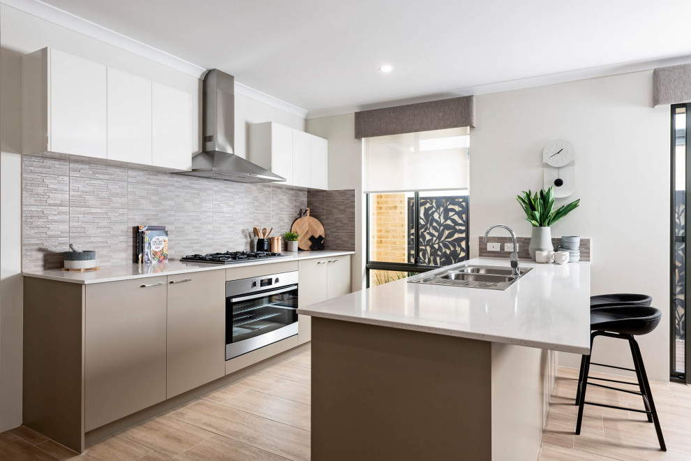 Design ideas for a contemporary galley kitchen in Perth with a drop-in sink, flat-panel cabinets, grey cabinets, grey splashback, stainless steel appliances, a peninsula, beige floor and white benchtop.