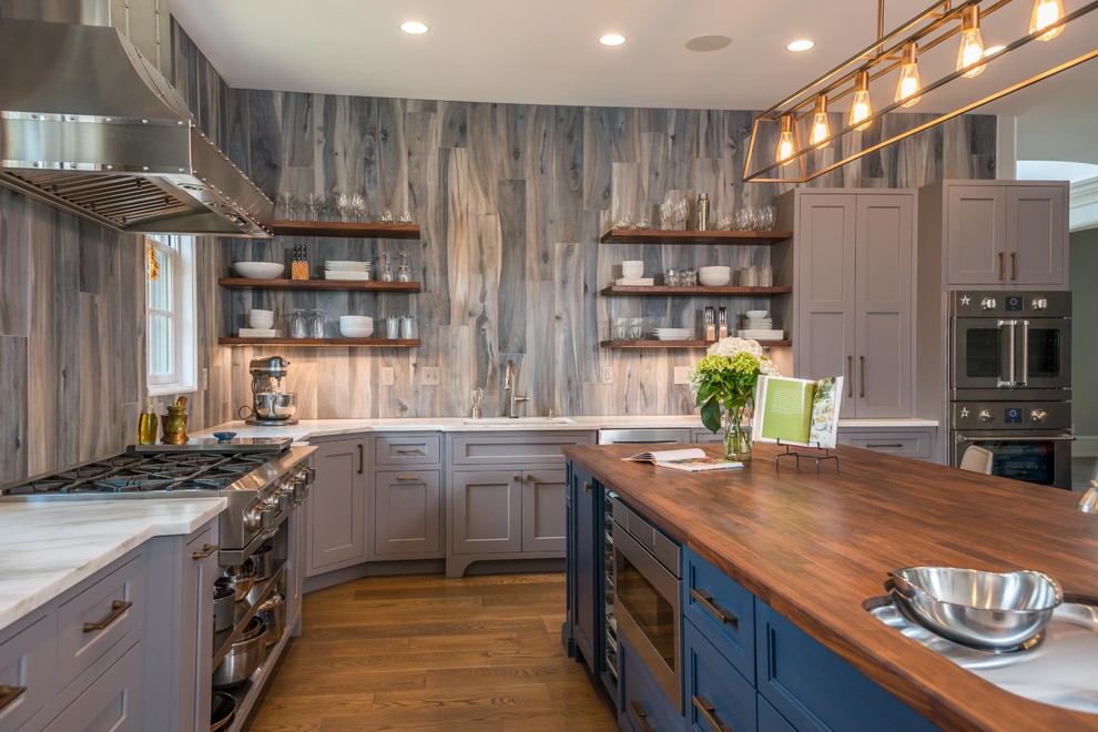 Inspiration for a large transitional l-shaped kitchen in Other with an undermount sink, shaker cabinets, grey cabinets, wood benchtops, grey splashback, stainless steel appliances, medium hardwood floors, with island, brown benchtop and brown floor.