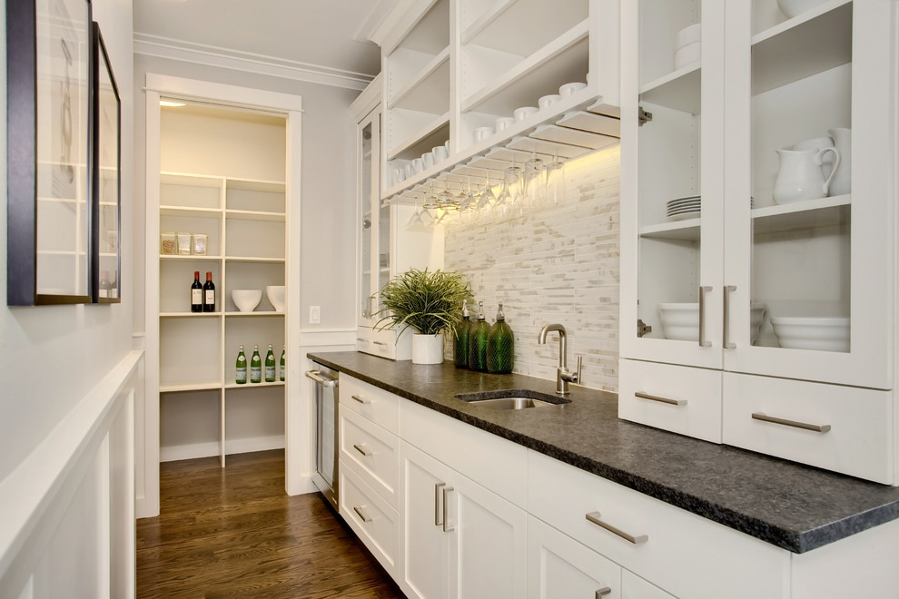 Photo of an arts and crafts kitchen pantry in Seattle with an undermount sink, recessed-panel cabinets, white cabinets, granite benchtops, multi-coloured splashback, porcelain splashback, stainless steel appliances, medium hardwood floors and with island.