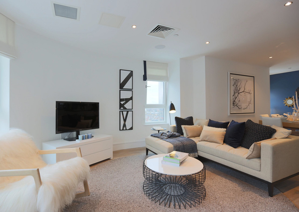 This is an example of a small contemporary formal living room in London with grey walls, dark hardwood floors and a concrete fireplace surround.