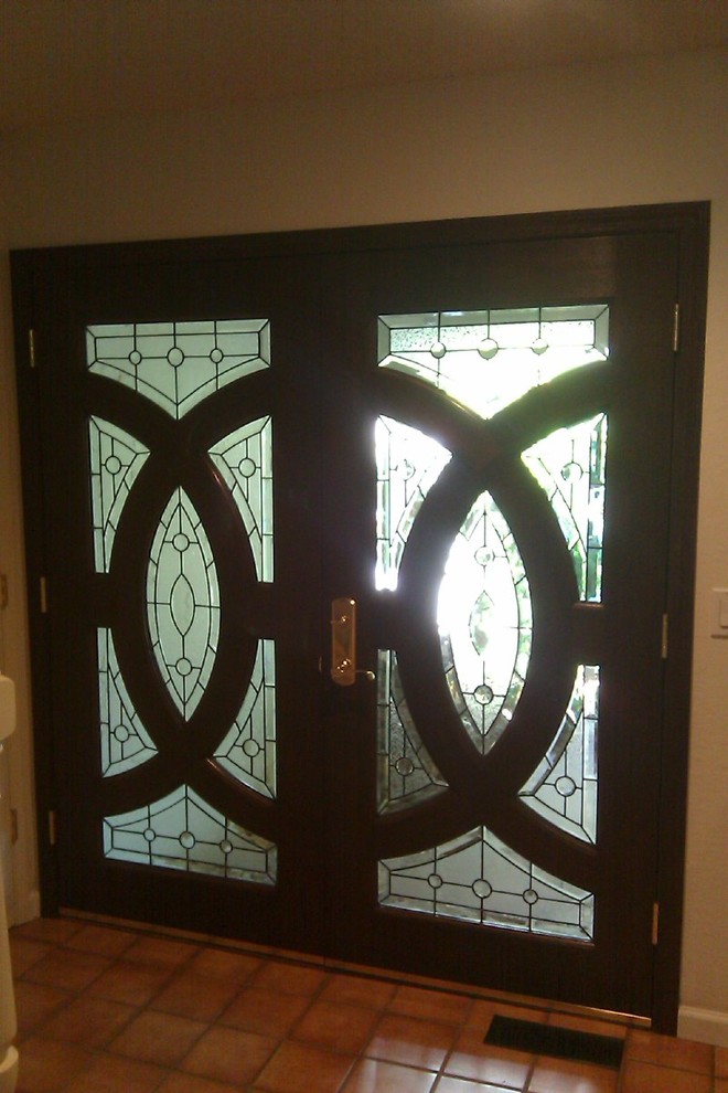 Example of a mid-sized transitional ceramic tile front door design with beige walls and a dark wood front door