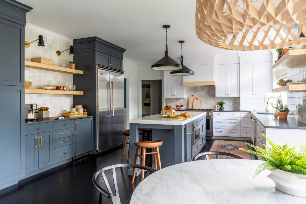Photo of a medium sized eclectic u-shaped enclosed kitchen in Bridgeport with a built-in sink, shaker cabinets, blue cabinets, granite worktops, white splashback, porcelain splashback, stainless steel appliances, cement flooring, an island, black floors, black worktops and a wood ceiling.