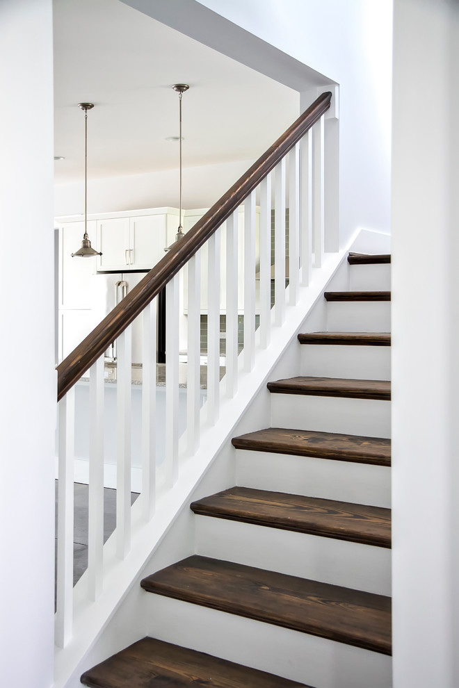 This is an example of a mid-sized modern wood l-shaped staircase in Jacksonville with painted wood risers.