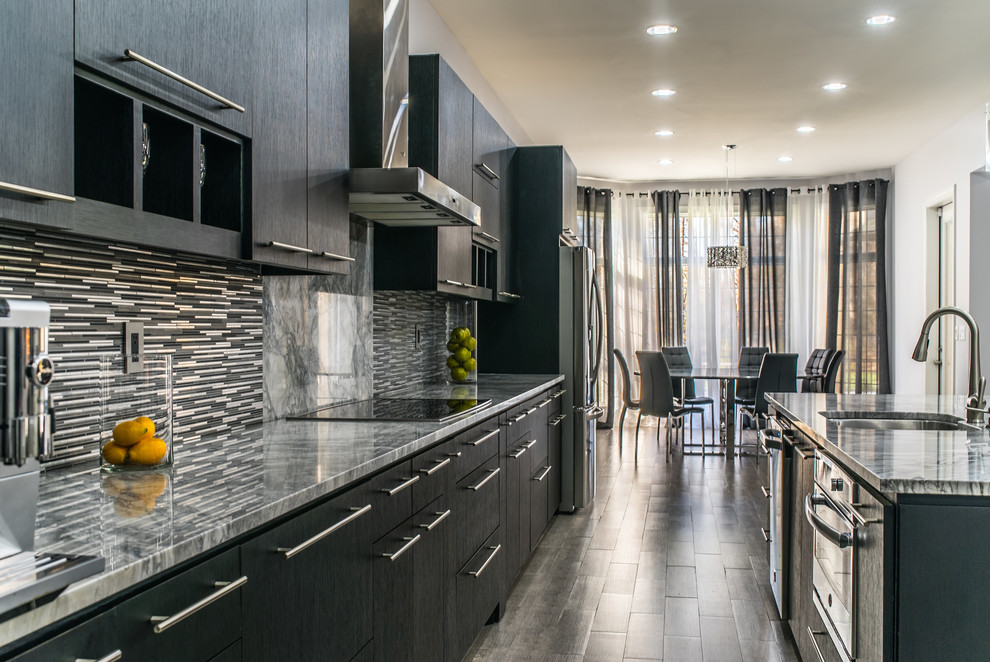 Expansive transitional single-wall kitchen pantry in Dallas with a double-bowl sink, flat-panel cabinets, black cabinets, marble benchtops, grey splashback, glass tile splashback, stainless steel appliances, ceramic floors, with island and grey floor.