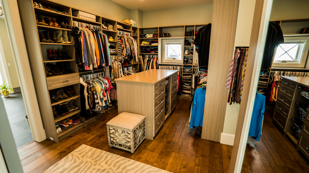 Photo of a large transitional walk-in wardrobe in Salt Lake City with shaker cabinets, light wood cabinets, medium hardwood floors and brown floor.