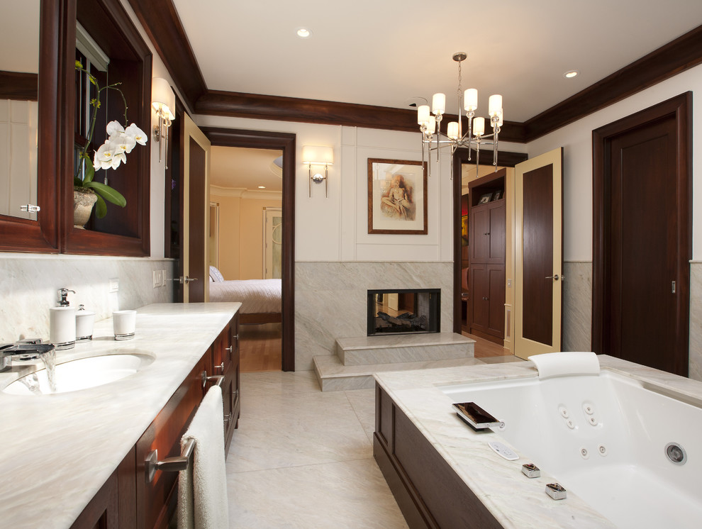 Inspiration for a large contemporary master bathroom in Chicago with furniture-like cabinets, dark wood cabinets, a double shower, a one-piece toilet, an undermount sink, an undermount tub and a hinged shower door.