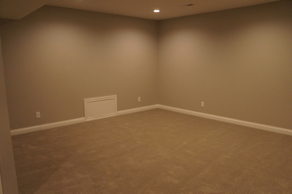 Example of a large transitional look-out carpeted basement design with beige walls