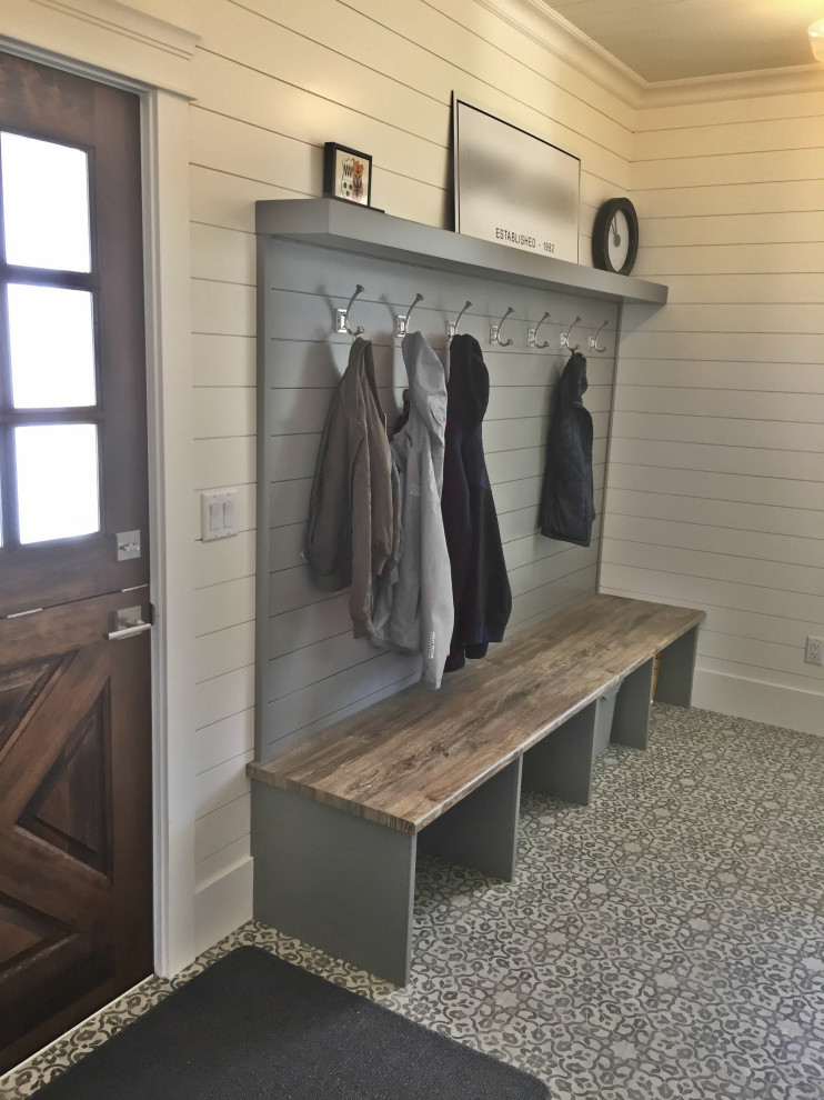 Photo of a country mudroom in Vancouver with white walls, vinyl floors, a dutch front door, a dark wood front door and multi-coloured floor.
