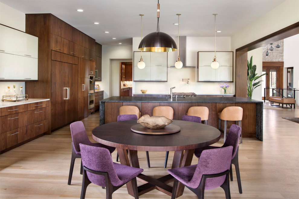 Example of a mid-sized trendy l-shaped medium tone wood floor eat-in kitchen design in Denver with an undermount sink, flat-panel cabinets, granite countertops, stainless steel appliances and an island