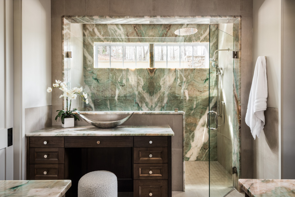 Large transitional master green tile and stone slab gray floor alcove shower photo with dark wood cabinets, beige walls, quartzite countertops, a hinged shower door, green countertops, a built-in vanity and recessed-panel cabinets