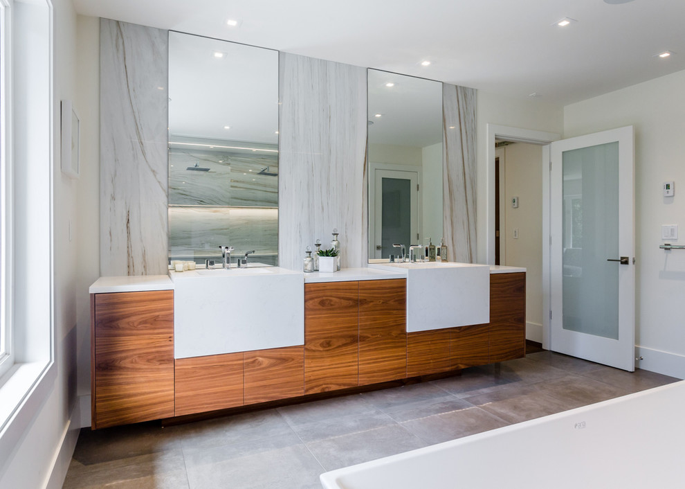 Photo of a large modern master bathroom in Vancouver with flat-panel cabinets, medium wood cabinets, a freestanding tub, a corner shower, white walls, cement tiles, an undermount sink, quartzite benchtops, grey floor, an open shower and white benchtops.