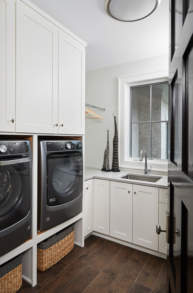 Inspiration for a mid-sized eclectic l-shaped dedicated laundry room in Grand Rapids with an undermount sink, recessed-panel cabinets, white cabinets, quartzite benchtops, grey walls, medium hardwood floors, a side-by-side washer and dryer and grey benchtop.