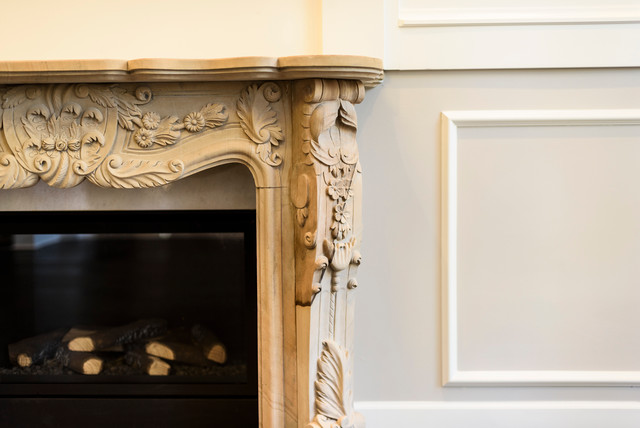 Example of a classic living room design in Vancouver with a standard fireplace and a stone fireplace