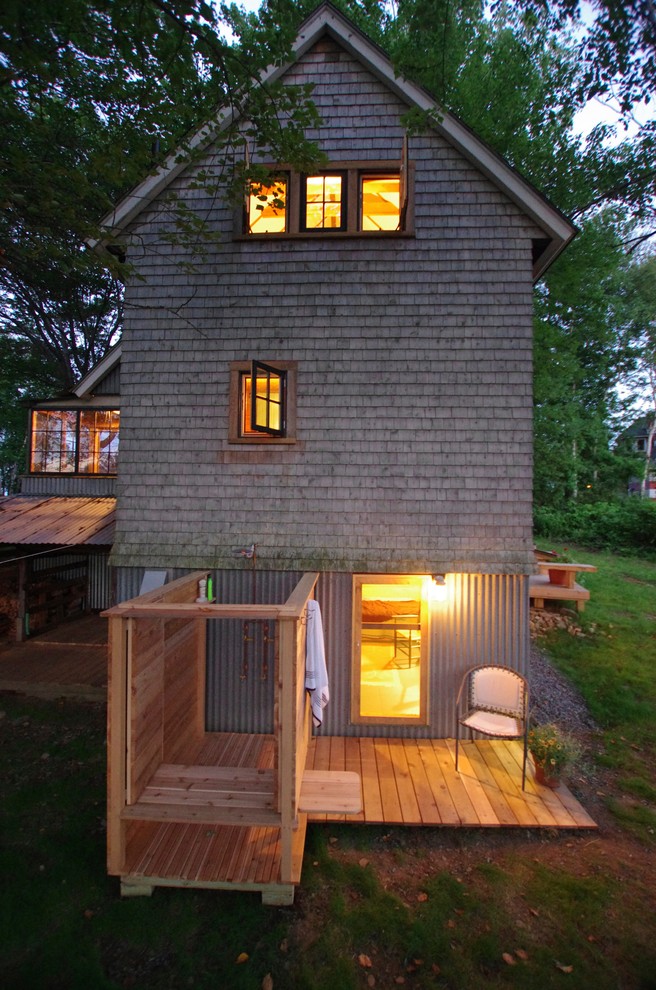This is an example of a small country side yard deck in Portland Maine with an outdoor shower.