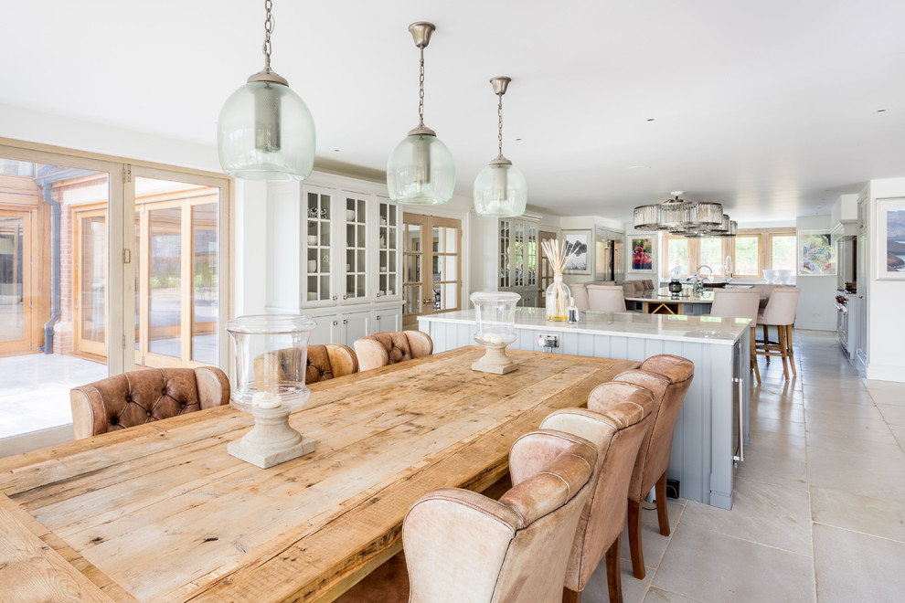 Large country eat-in kitchen in West Midlands with a farmhouse sink, shaker cabinets, grey cabinets, marble benchtops, white splashback, ceramic splashback, stainless steel appliances, porcelain floors, multiple islands and white floor.