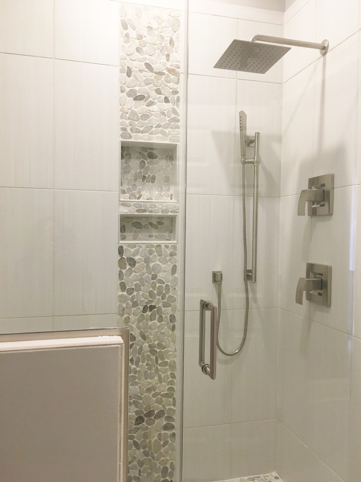 Mid-sized contemporary kids bathroom in Raleigh with shaker cabinets, grey cabinets, an open shower, a two-piece toilet, multi-coloured tile, glass sheet wall, grey walls, porcelain floors, a trough sink, quartzite benchtops, grey floor and a hinged shower door.
