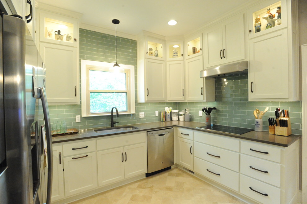 Inspiration for a transitional u-shaped travertine floor kitchen remodel in Atlanta with a single-bowl sink, recessed-panel cabinets, white cabinets, quartz countertops, green backsplash, glass tile backsplash, stainless steel appliances and an island