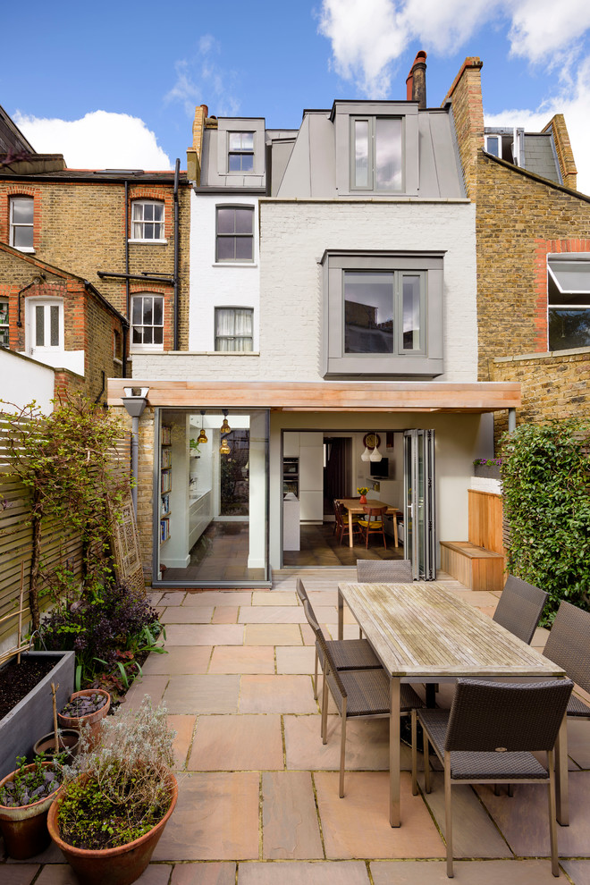 Mid-sized traditional backyard patio in London with no cover.