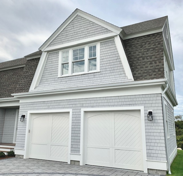 Design ideas for a large beach style attached two-car garage in Boston.