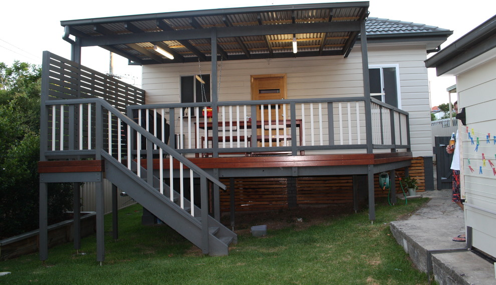 Inspiration for a small contemporary backyard deck in Newcastle - Maitland with a roof extension.