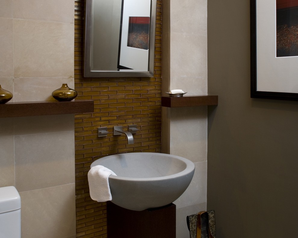 Design ideas for a small contemporary powder room in Miami with a one-piece toilet, brown tile, glass tile, beige walls and a vessel sink.