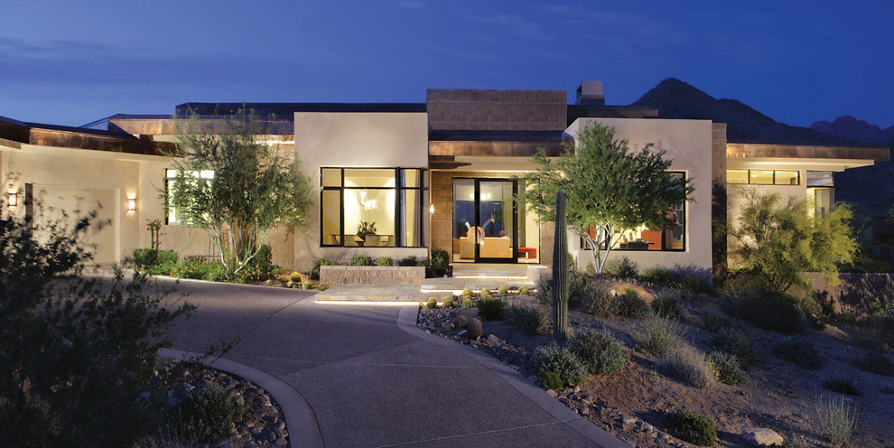 This is an example of a mid-sized contemporary one-storey concrete grey house exterior in Phoenix with a flat roof.