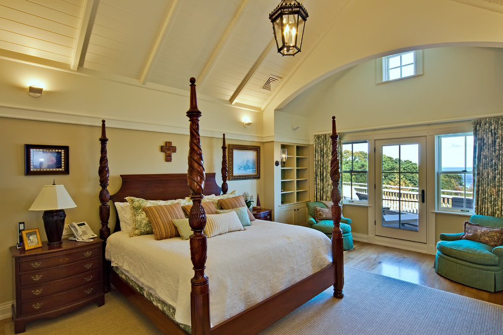 Inspiration for a large traditional master bedroom in Boston with yellow walls and medium hardwood floors.
