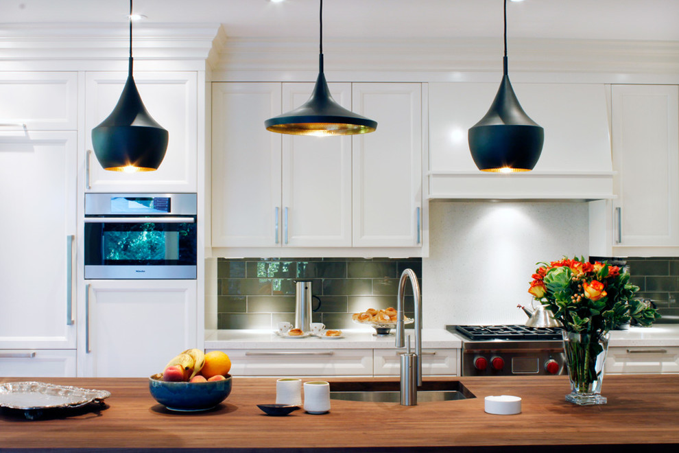 Open concept kitchen - large transitional l-shaped medium tone wood floor open concept kitchen idea in Toronto with an undermount sink, recessed-panel cabinets, white cabinets, quartz countertops, gray backsplash, glass tile backsplash, paneled appliances and an island