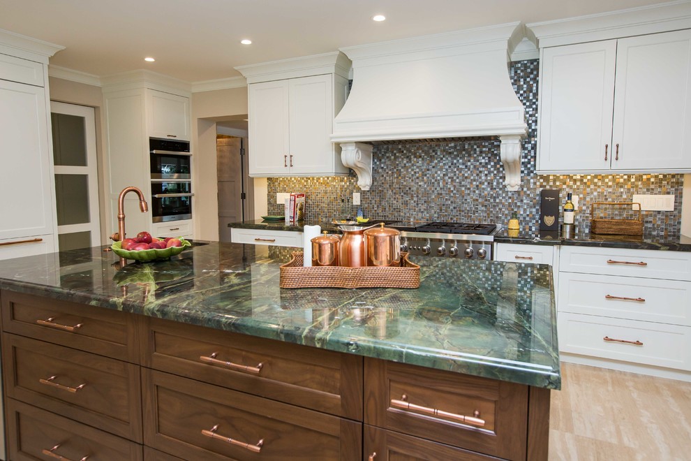 Large transitional u-shaped light wood floor open concept kitchen photo in Miami with a farmhouse sink, shaker cabinets, stainless steel appliances, an island, white cabinets, granite countertops, metallic backsplash and mosaic tile backsplash