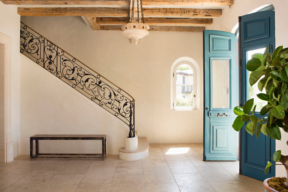 Inspiration for a mediterranean foyer in Orange County with travertine floors and beige floor.