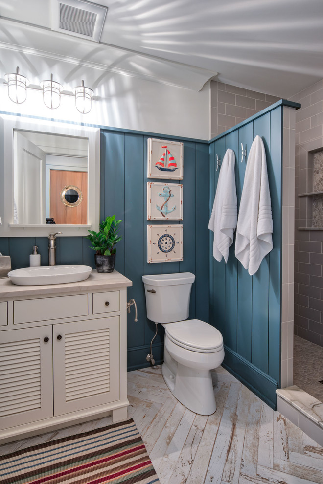 Design ideas for an expansive beach style 3/4 bathroom in Minneapolis with louvered cabinets, white cabinets, an open shower, beige tile, pebble tile and engineered quartz benchtops.