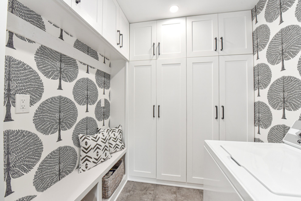 Foto di una piccola lavanderia multiuso minimalista con ante in stile shaker, ante bianche, pavimento con piastrelle in ceramica, lavatrice e asciugatrice affiancate e carta da parati