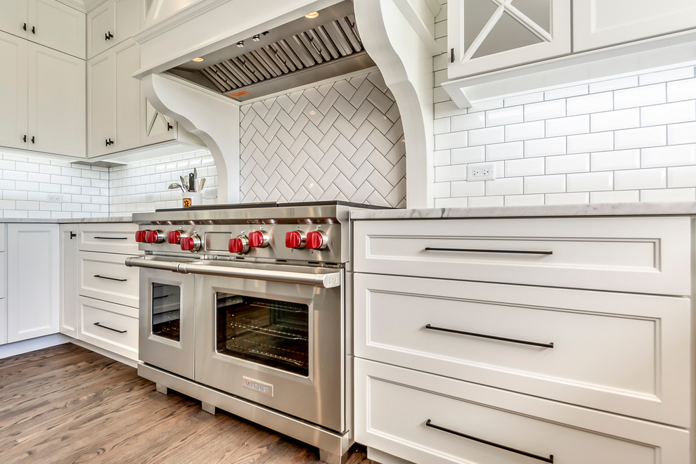 Open concept kitchen - transitional open concept kitchen idea in Chicago with white backsplash, subway tile backsplash and two islands