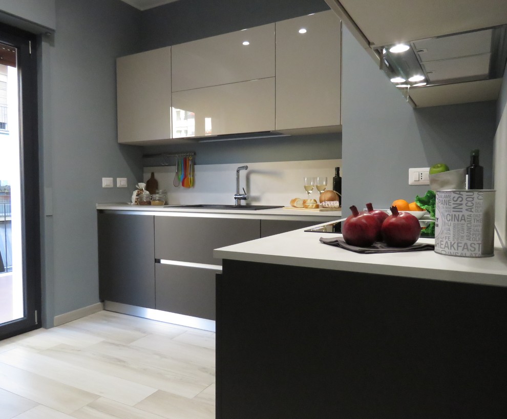 Design ideas for a small modern galley open plan kitchen in Catania-Palermo with a drop-in sink, flat-panel cabinets, quartz benchtops, beige splashback, stainless steel appliances, porcelain floors, no island and beige floor.