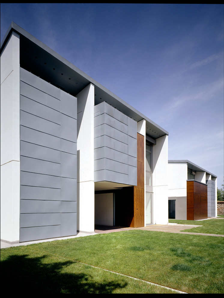 This is an example of a contemporary two-storey exterior in Milan with mixed siding.