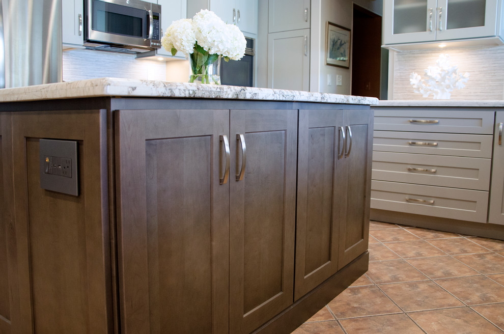 Inspiration for a mid-sized transitional u-shaped open concept kitchen remodel in Miami with an undermount sink, shaker cabinets, gray cabinets, quartzite countertops, gray backsplash, porcelain backsplash, stainless steel appliances and an island