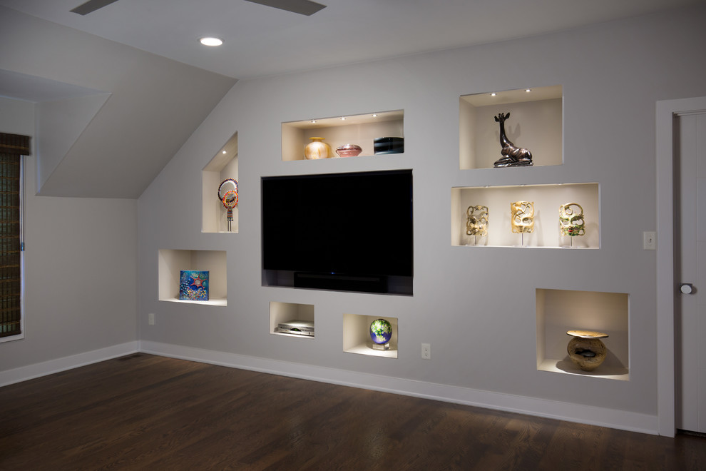 This is an example of a contemporary family room in Kansas City with a home bar, grey walls, medium hardwood floors and a built-in media wall.