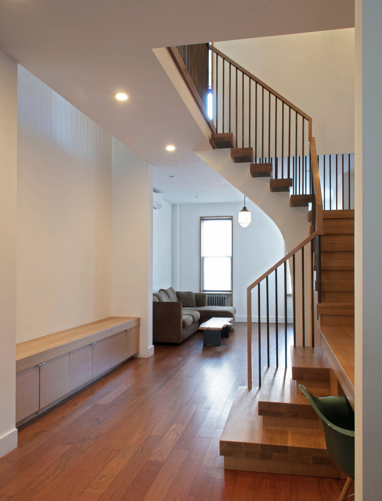 Photo of a mid-sized contemporary wood l-shaped staircase in New York with wood risers.