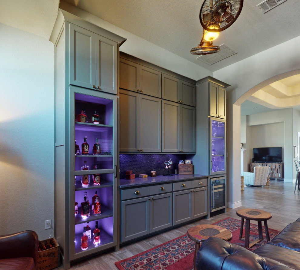 Design ideas for a large traditional single-wall home bar in Dallas with no sink, shaker cabinets, grey cabinets, granite benchtops, brown splashback, ceramic splashback, ceramic floors, grey floor and grey benchtop.