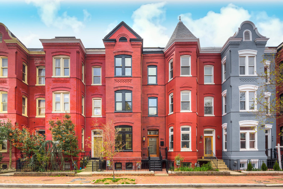 Design ideas for a mid-sized traditional three-storey brick red townhouse exterior in DC Metro with a gable roof and a shingle roof.